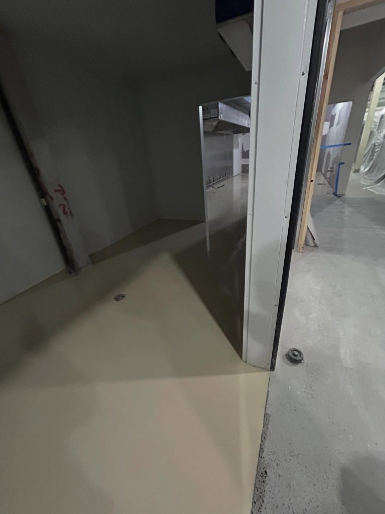Solid epoxy install with beige basecoat and door frame